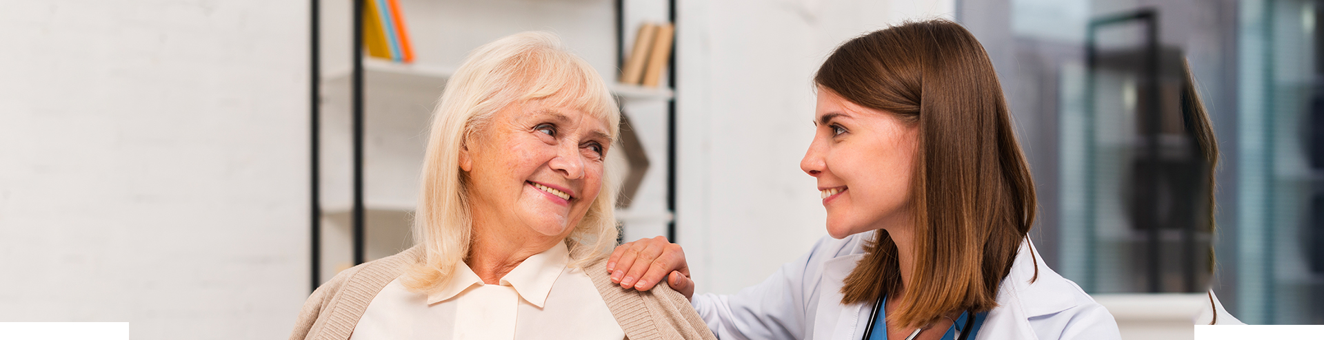 Healthcare staff interacting with a senior resident.