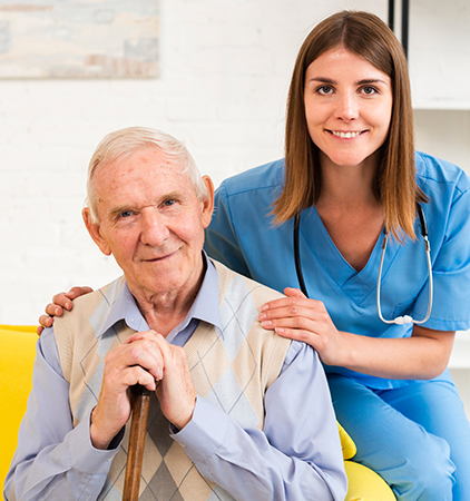 Healthcare worker with elderly resident smiling together