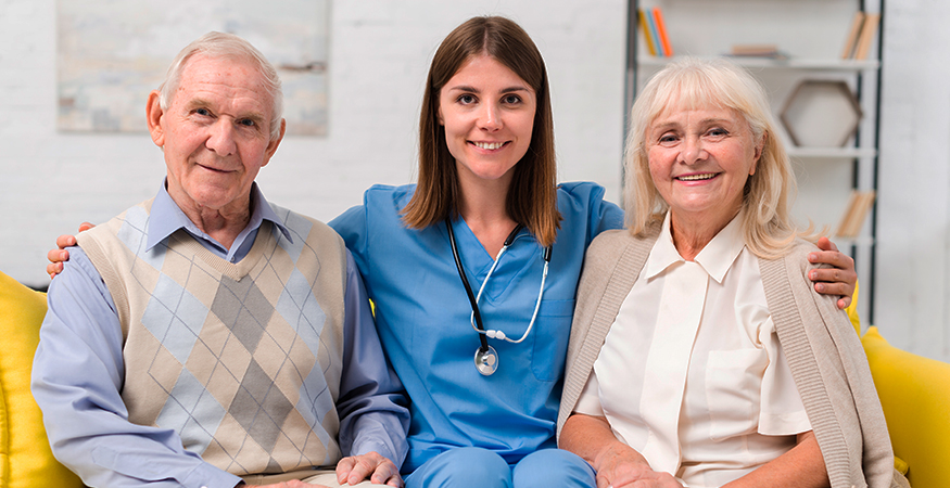 Senior residents with caregiver in common area