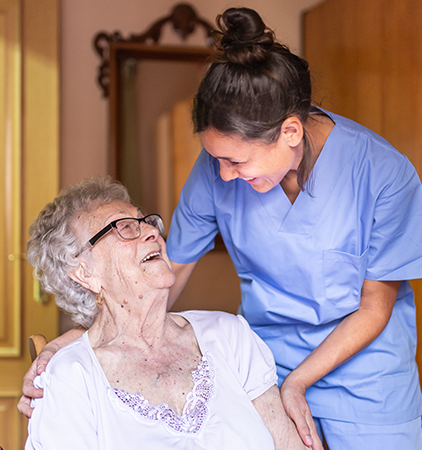 Caregiver smiling at an elderly resident