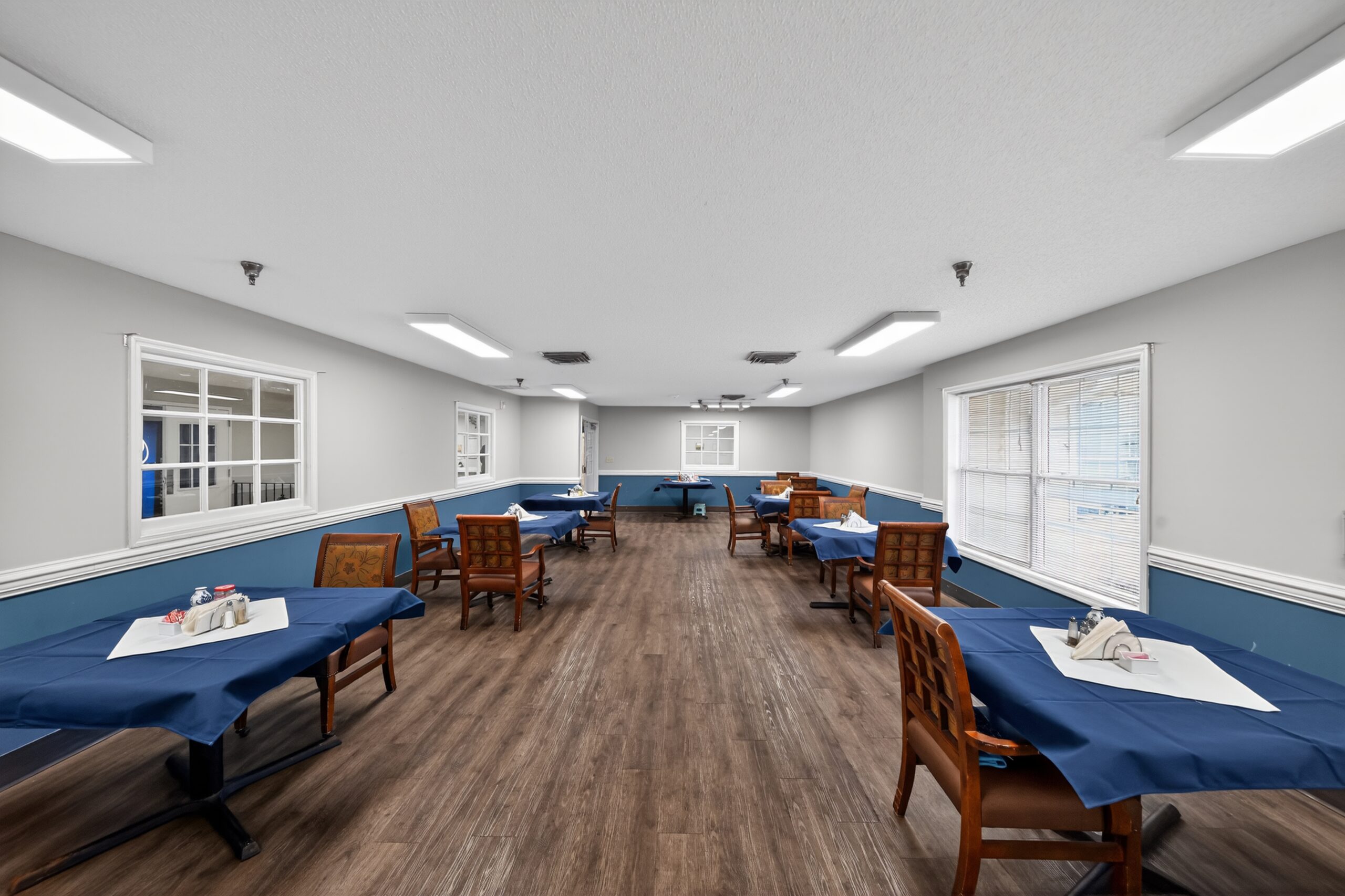 Bright dining room with tables set for meals