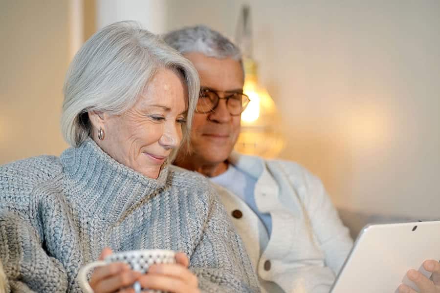 Senior couple enjoying time together with a tablet