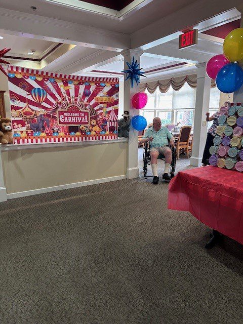 Residents participating in a carnival-themed event indoors.