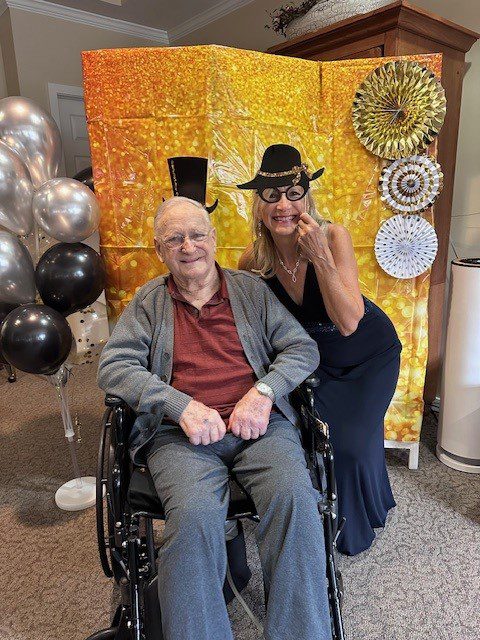 Resident and staff member celebrating at a party.