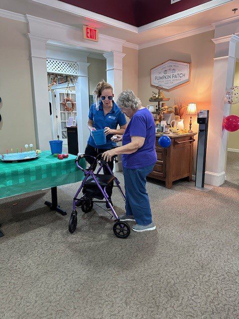 A staff member assisting a resident in a common area.
