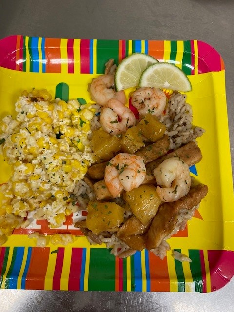 Colorful plate of shrimp and corn dish.