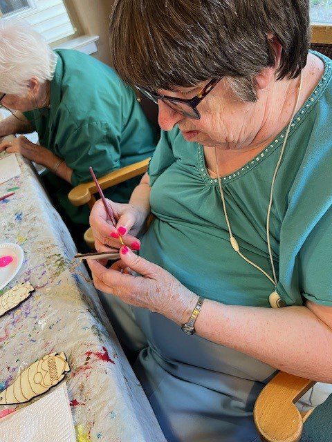Resident creating art in a craft activity