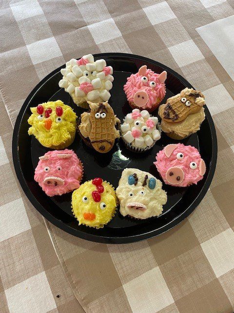 Decorative cupcakes with animal designs on a plate