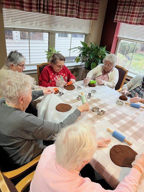 Residents engaging in a craft activity at a table.
