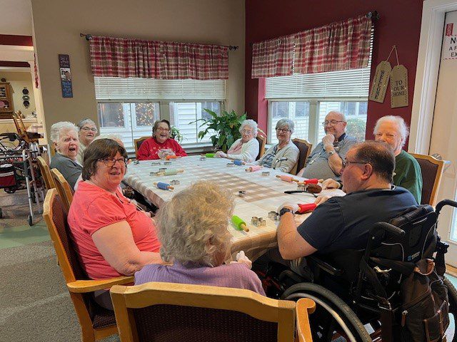 Residents engaged in an activity around a table.