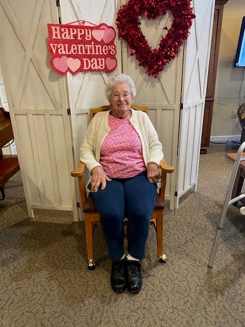 Resident celebrating Valentine's Day in the common area.