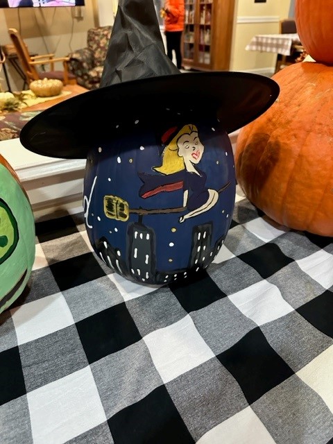 Decorated pumpkin with witch theme on a table