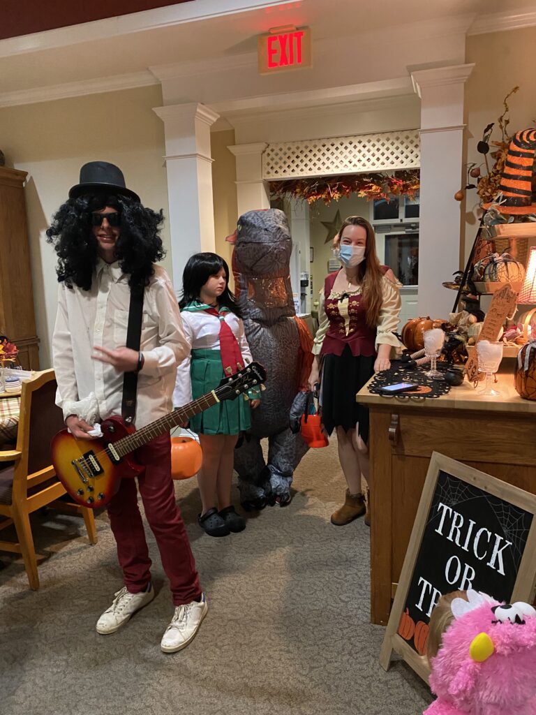 Residents and staff in costumes celebrating Halloween