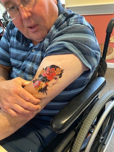 Resident showing off a colorful arm tattoo.