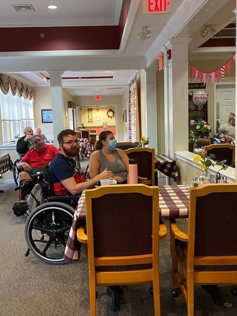 Residents enjoying a meal in the dining room.