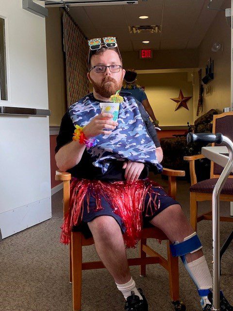 Resident enjoying a festive activity with a drink