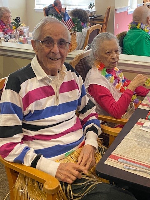 Two residents enjoying an activity indoors.