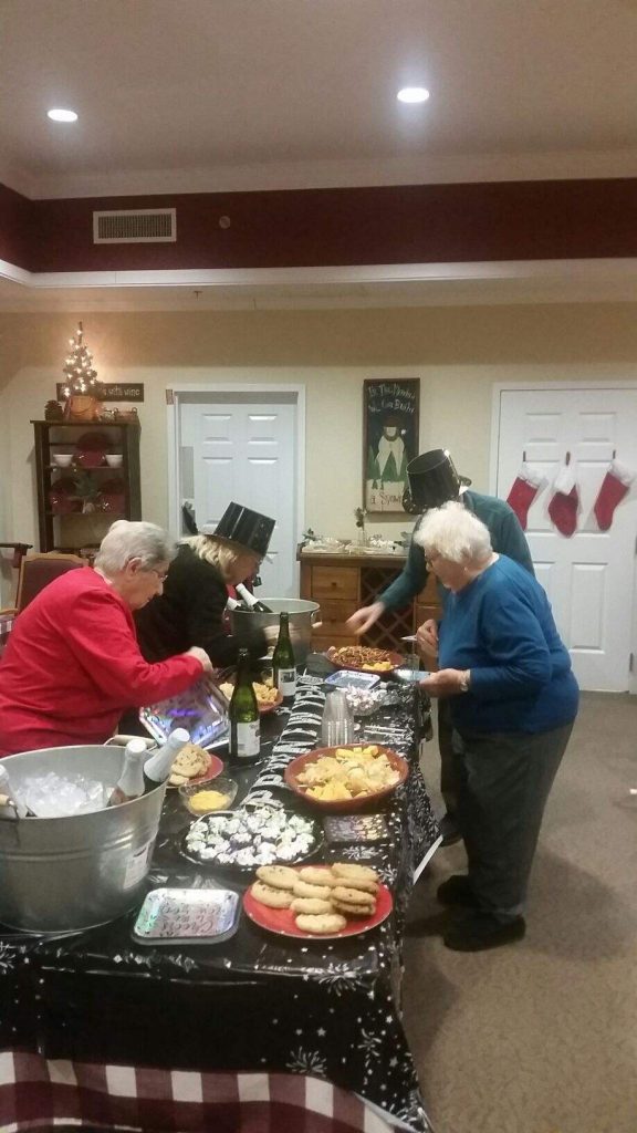 Residents enjoying a festive gathering with food and drinks.