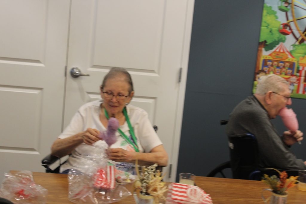 Residents enjoying activities with crafts and treats.