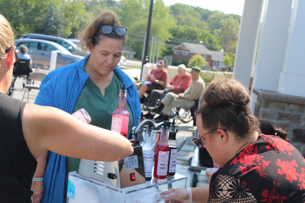 Residents enjoying an outdoor activity with refreshments.