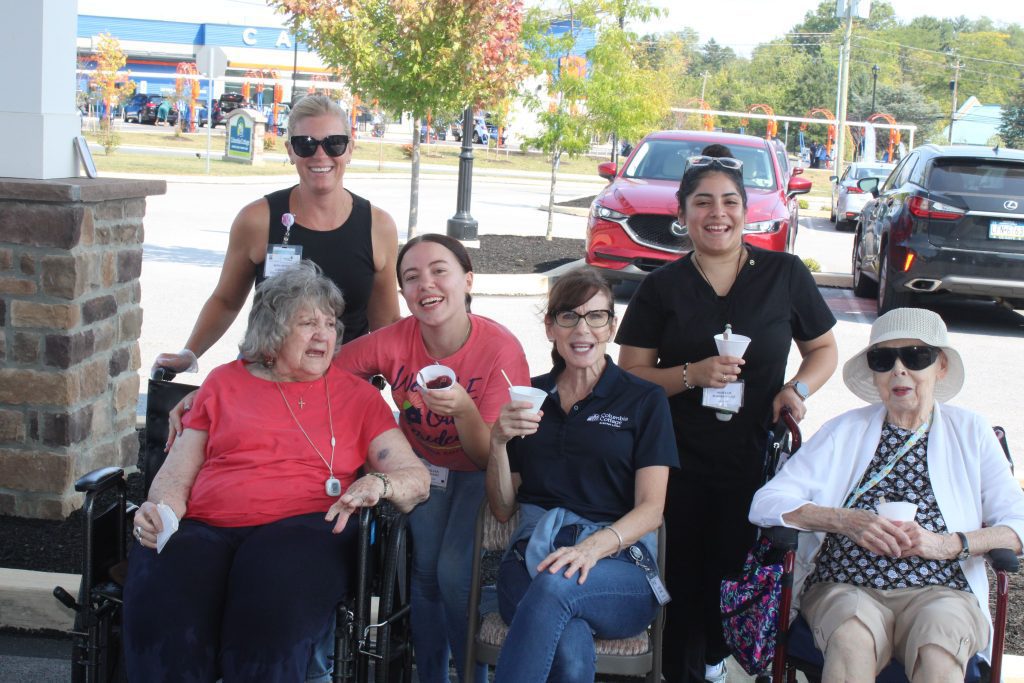 Residents and staff enjoying ice cream outdoors