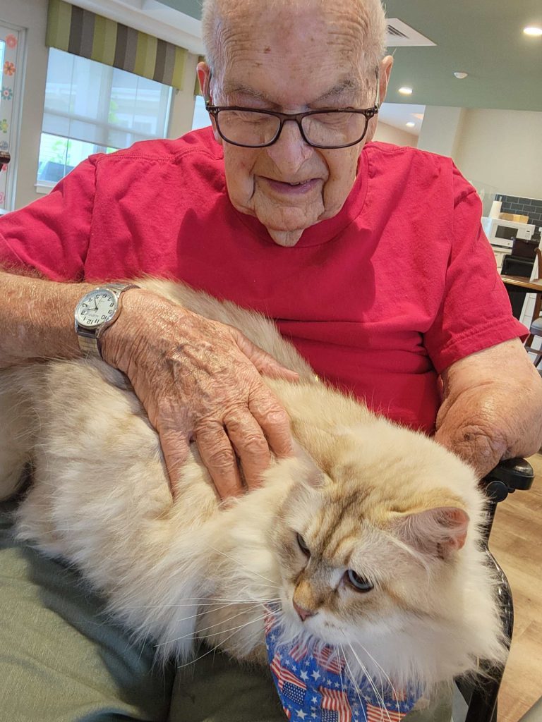 Senior resident interacts with a cat.
