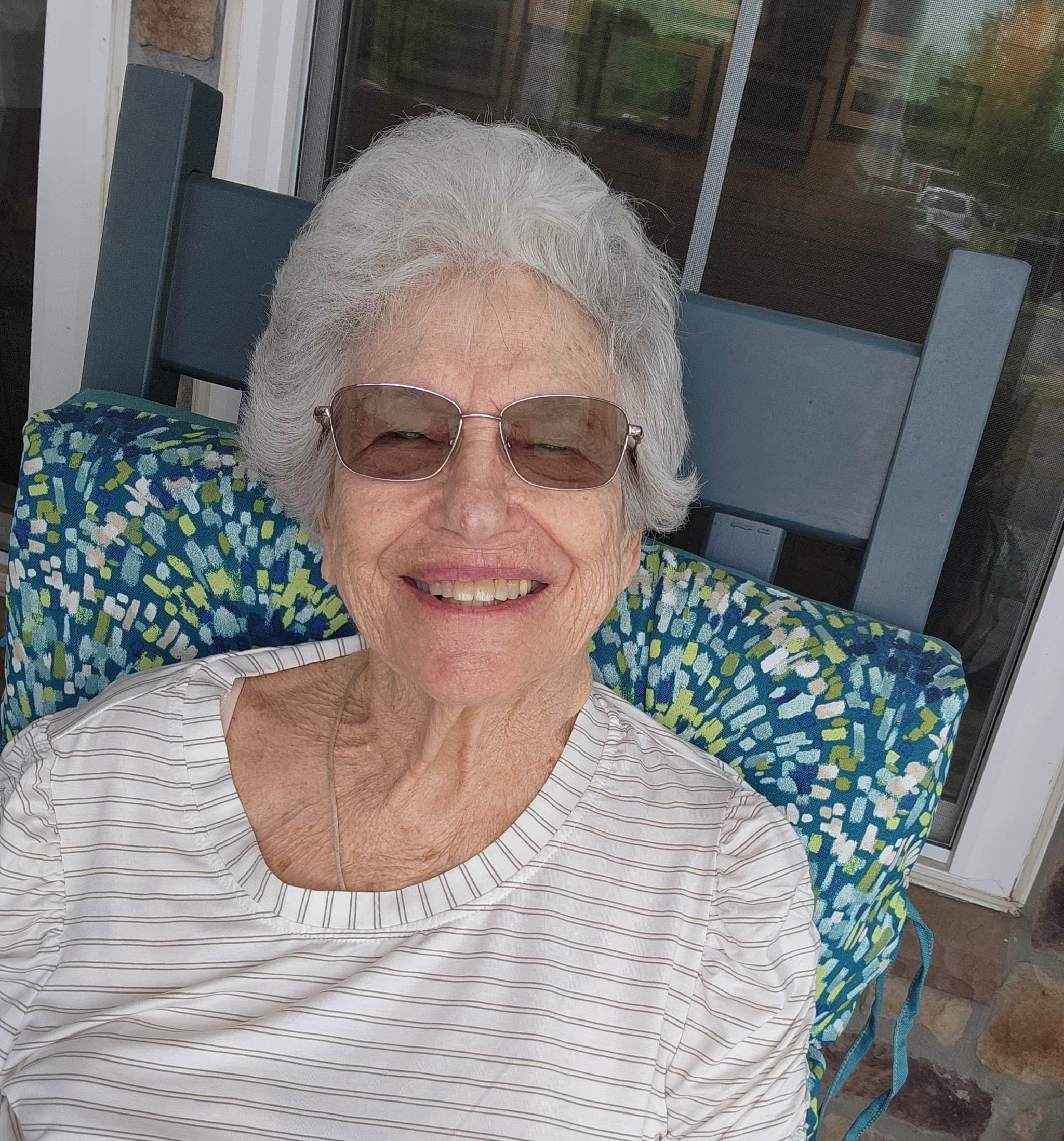 Senior resident smiling in a chair
