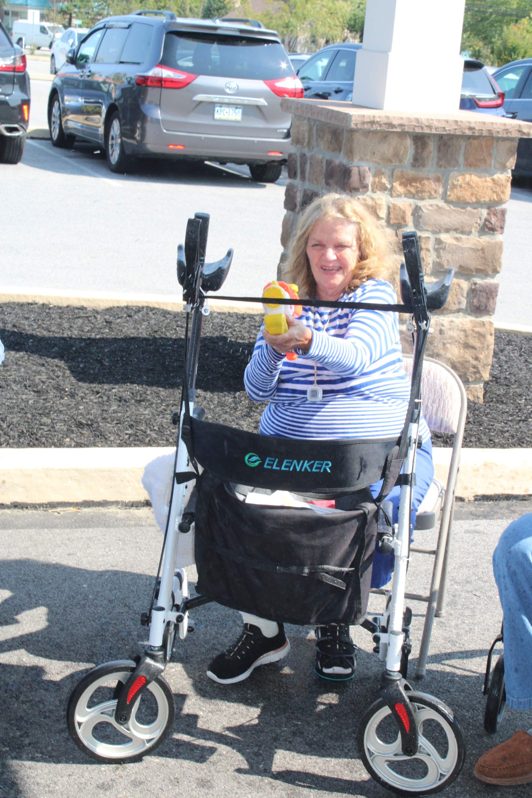Resident enjoying time outdoors with a walker.