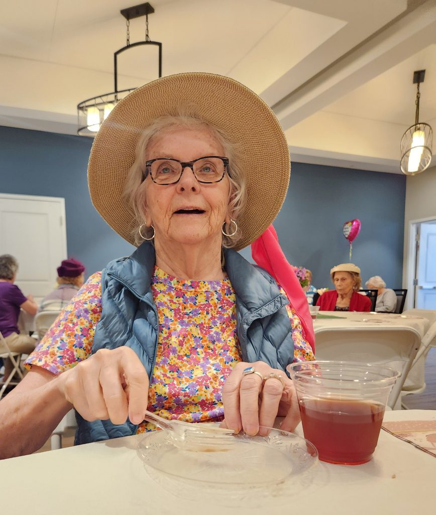 Senior resident enjoying a meal in the dining area.