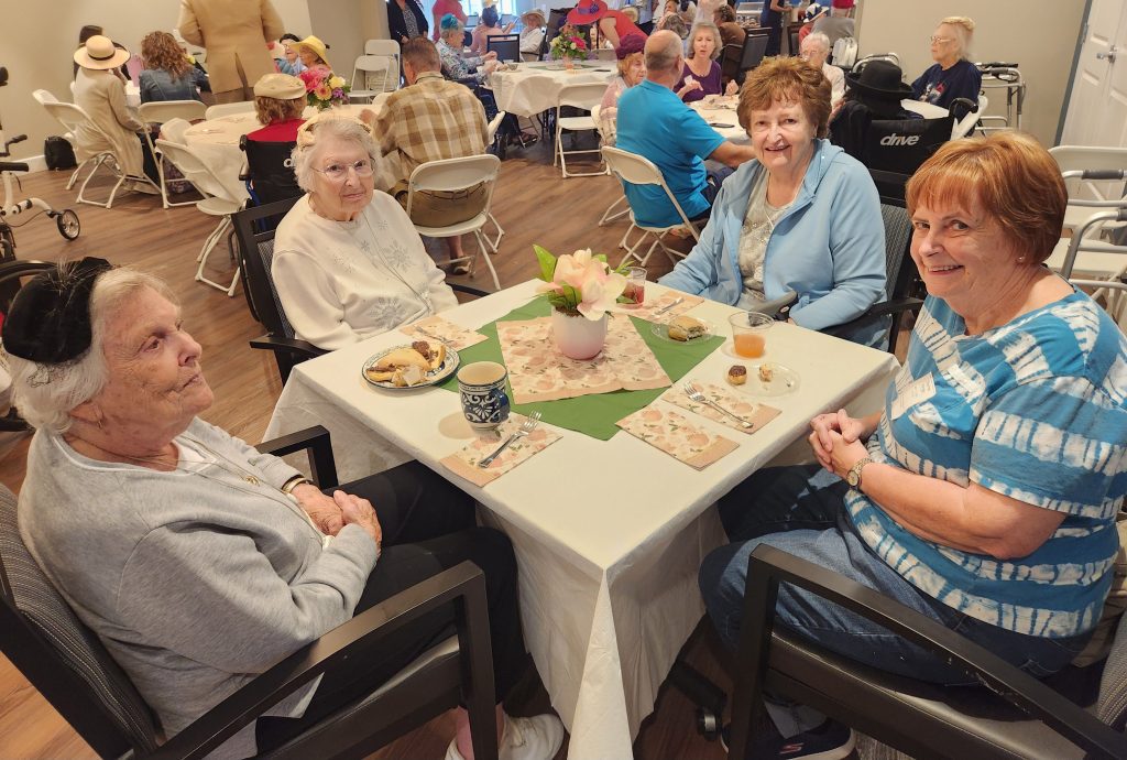Residents enjoying refreshments at a table