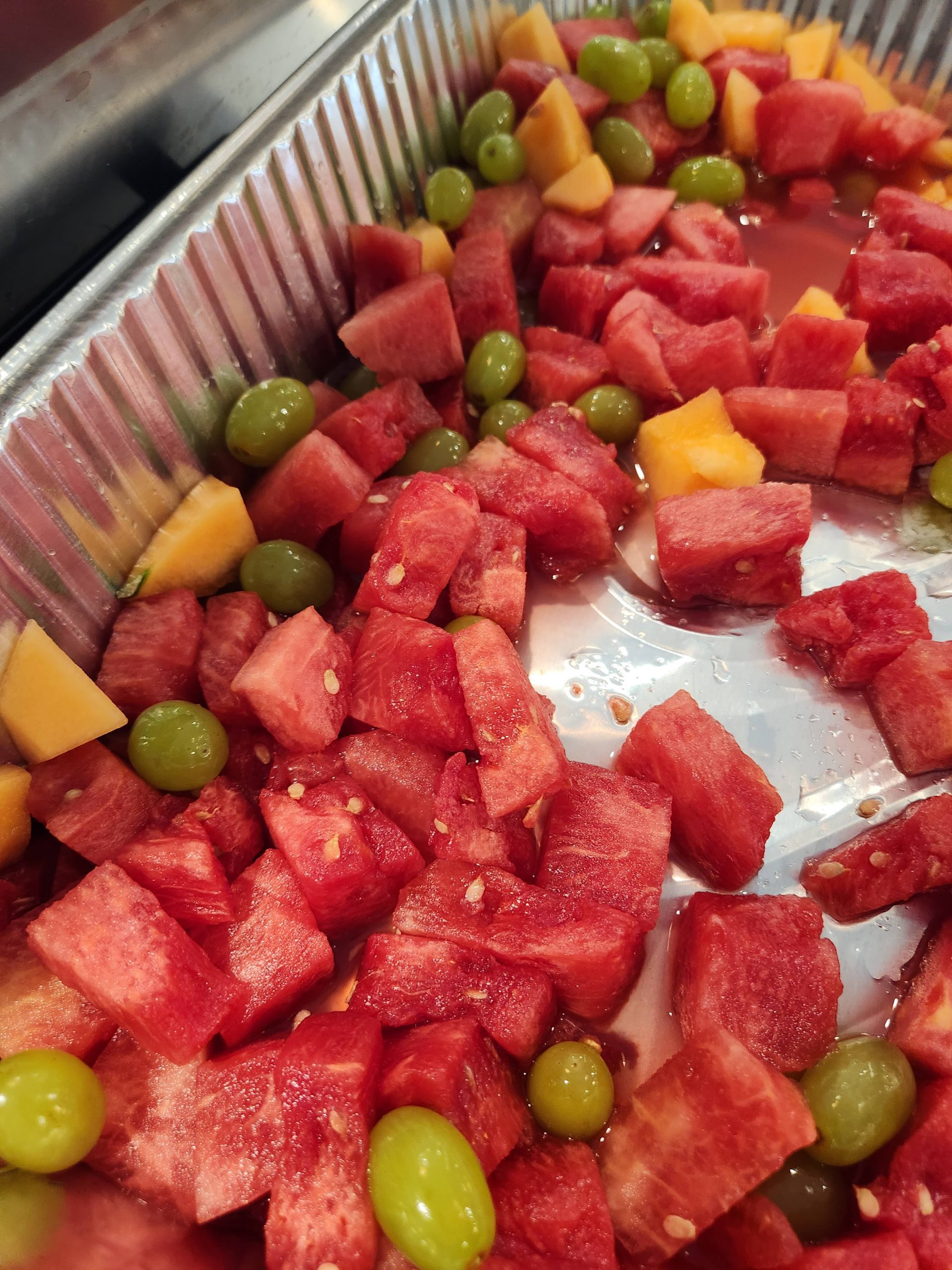 Fruit salad mix with watermelon, cantaloupe, and grapes.