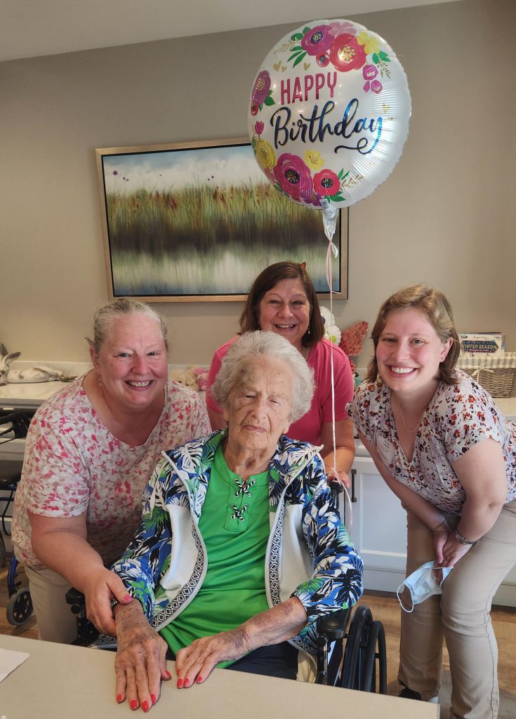 Residents celebrate a birthday with staff.