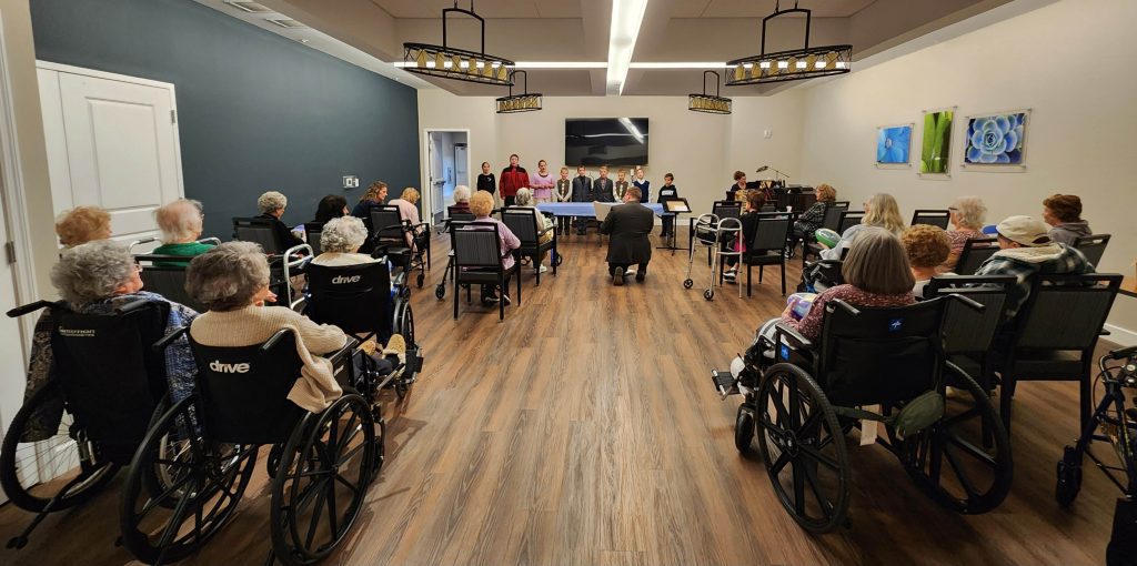 Residents enjoying an indoor activity in wheelchairs.