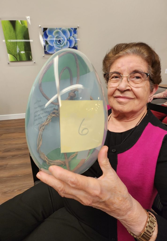 Resident holding a decorative glass piece.