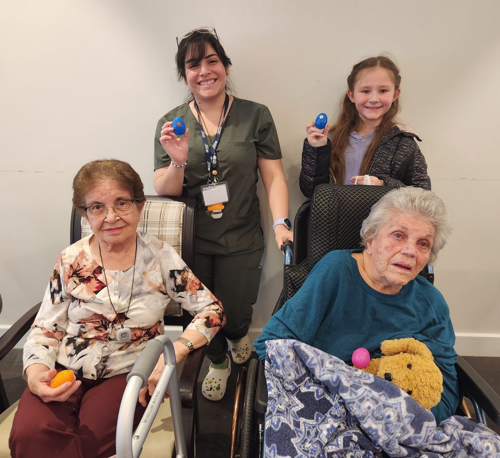 Residents and staff celebrate with colorful eggs.