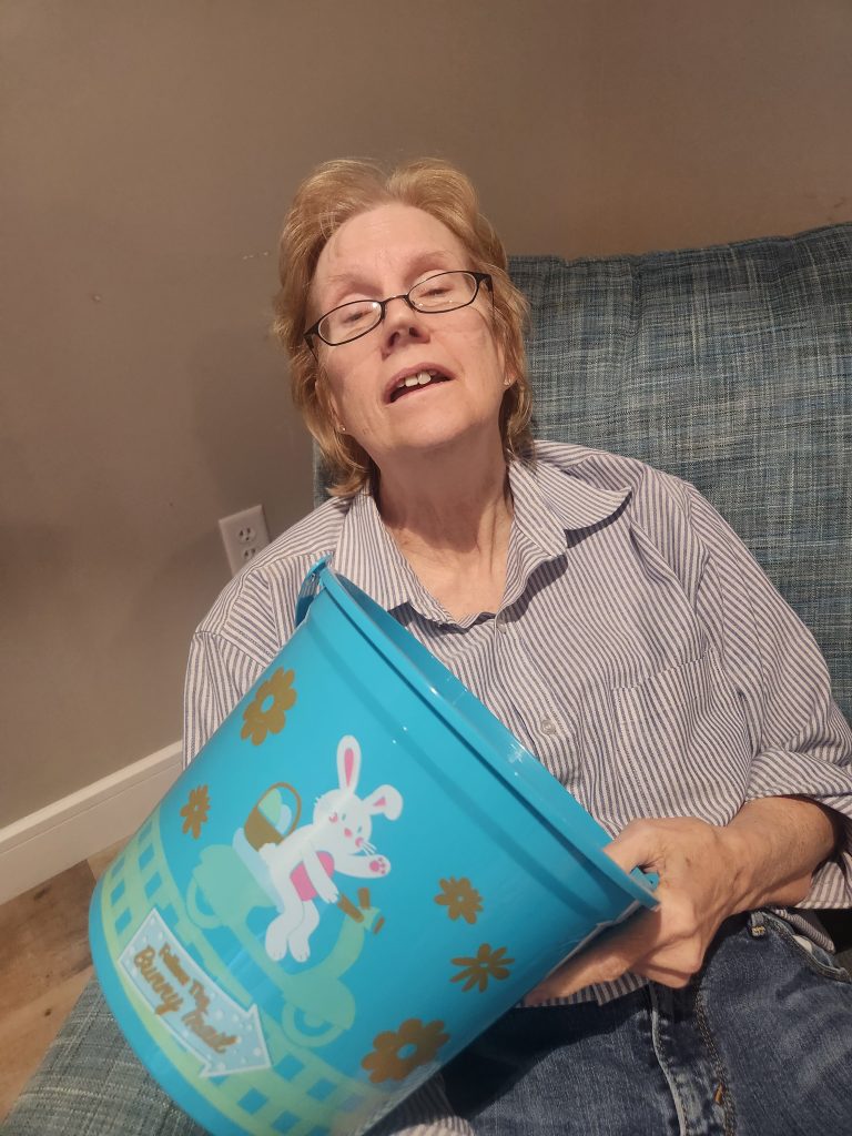 Resident enjoying a playful moment with a bucket.