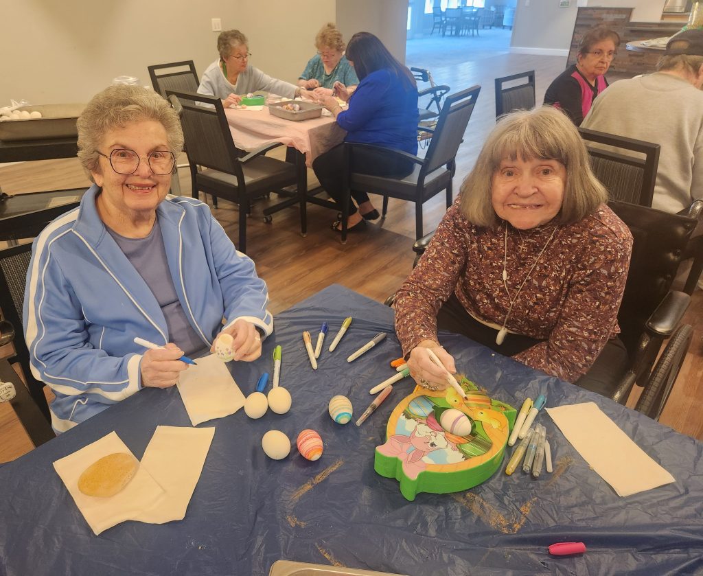 Two residents engaging in an art activity