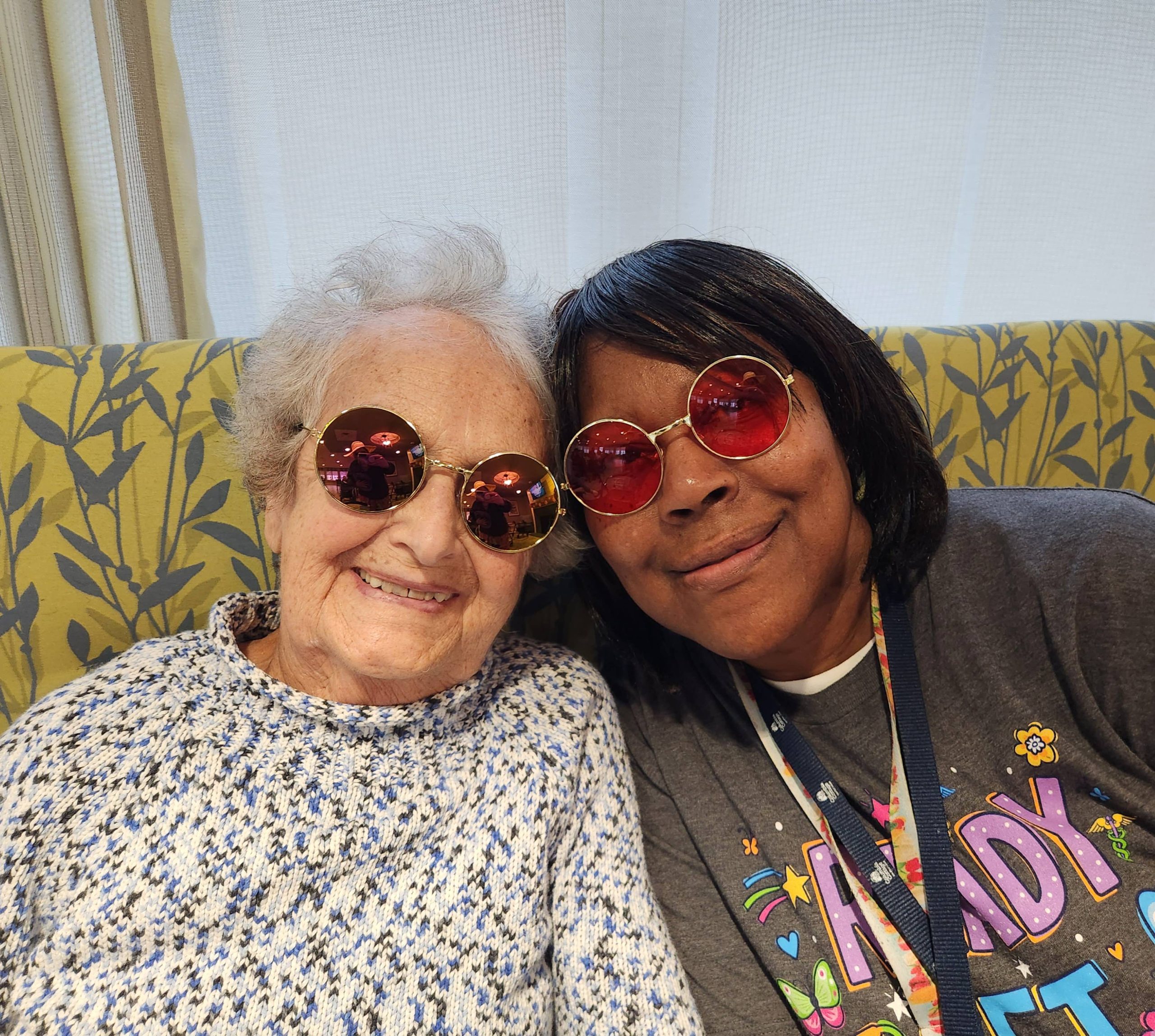 Two residents enjoying time together in colorful sunglasses.