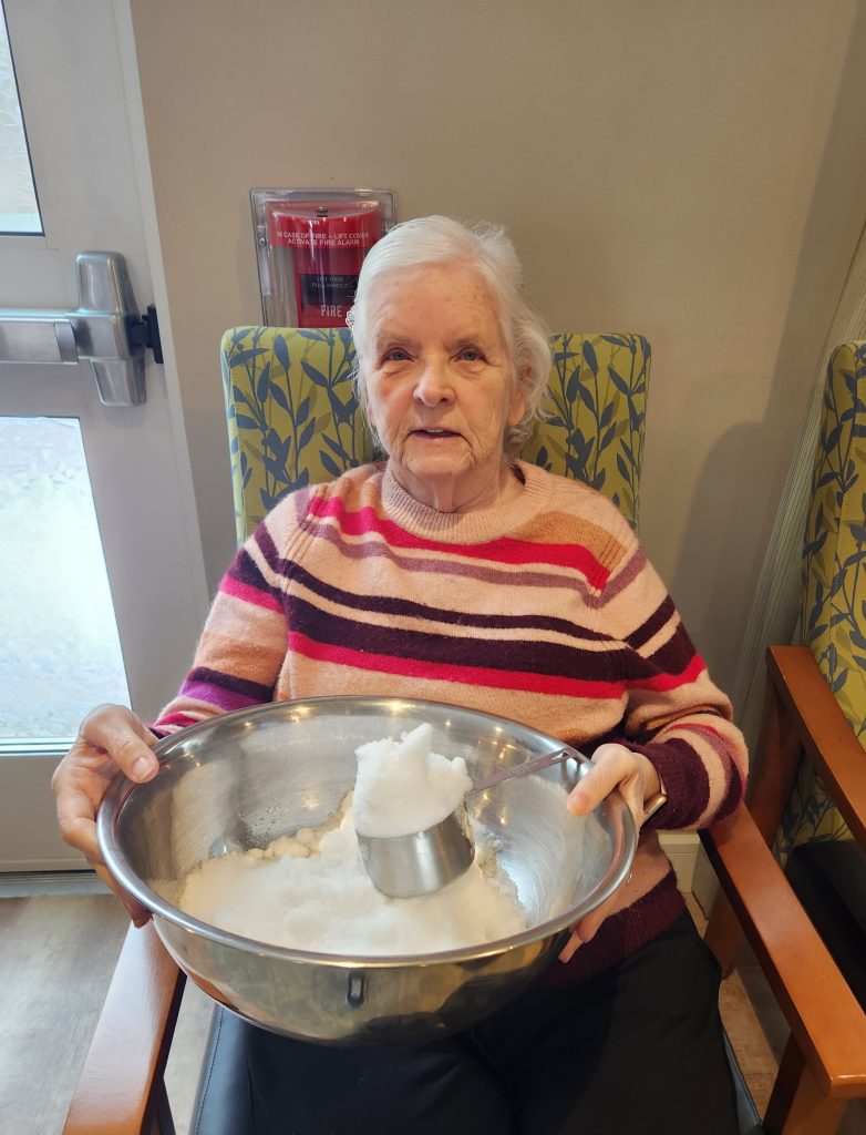 Resident engaging in an activity with a mixing bowl.