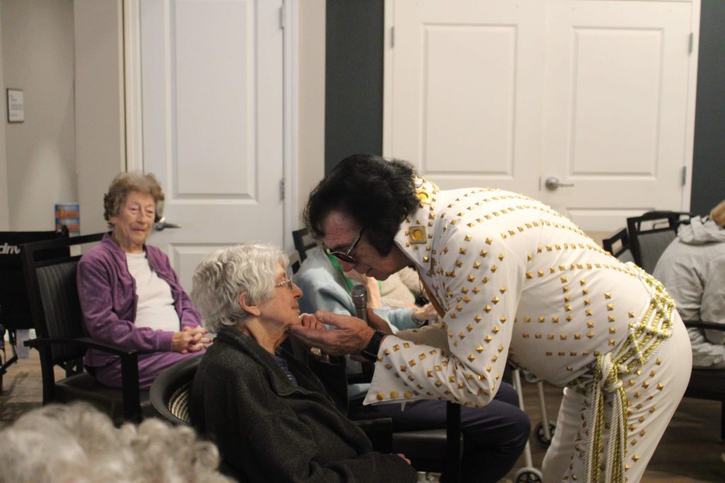 Residents enjoying a performance in a common area