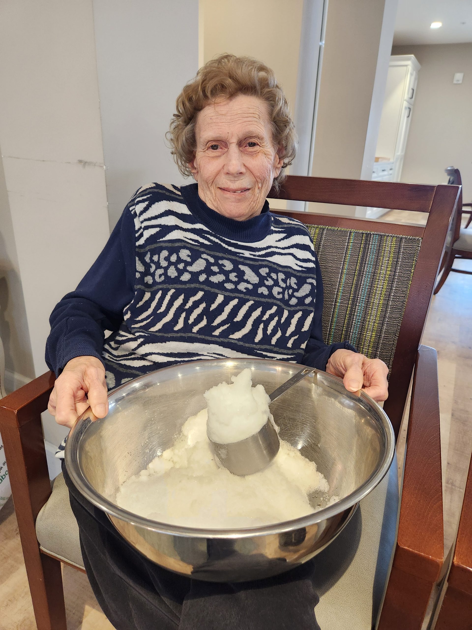 Resident mixing ingredients in a bowl.
