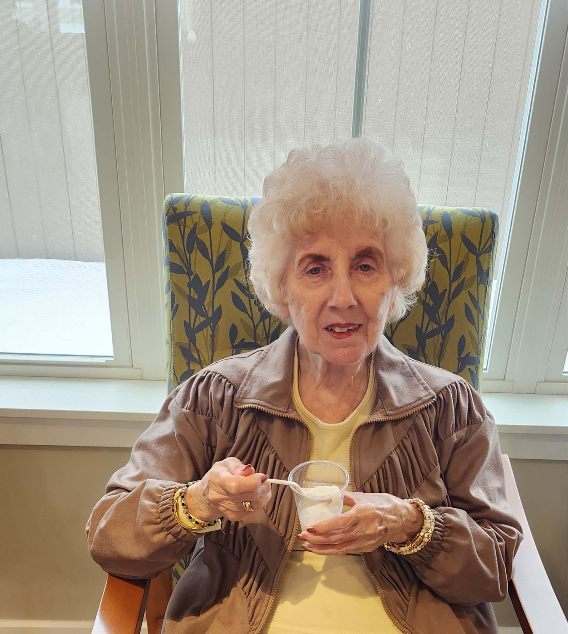 Resident enjoying dessert in a cozy setting