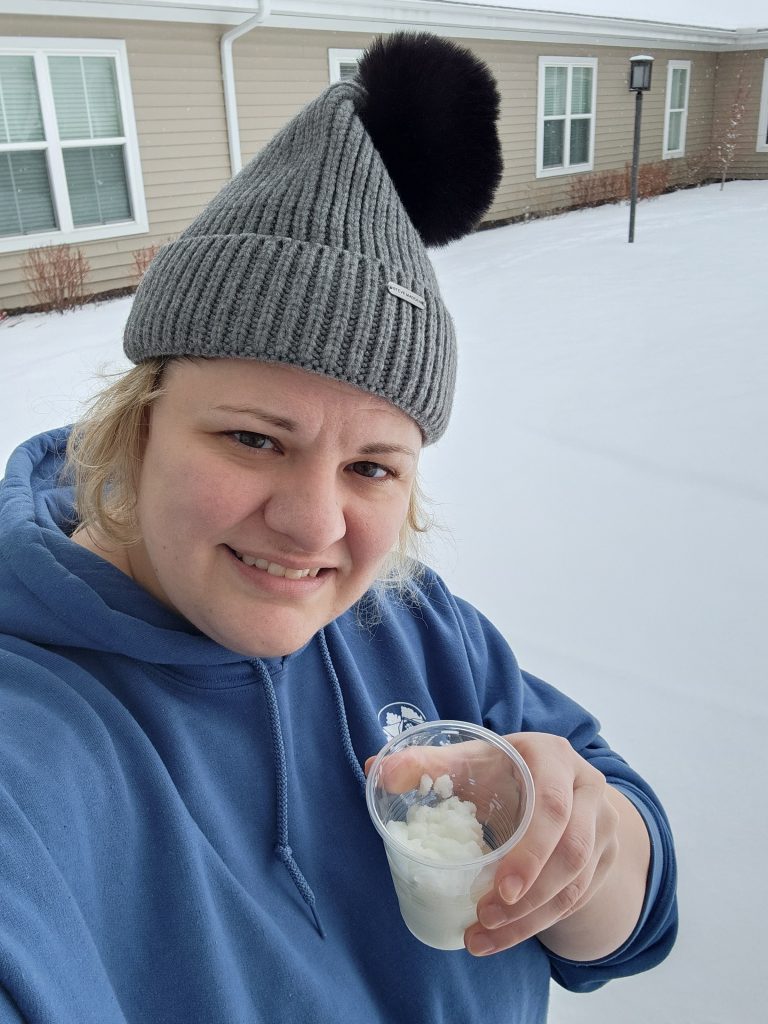Resident enjoying snowy weather with a cup