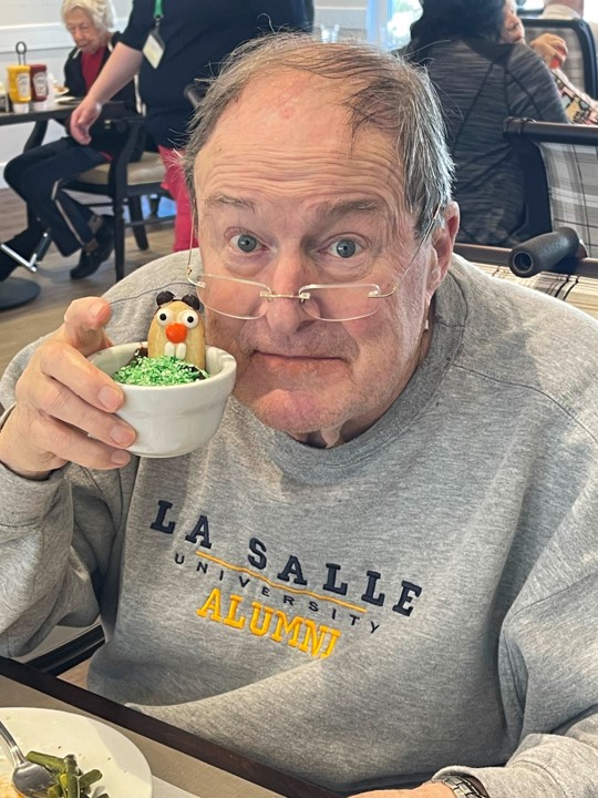 Resident enjoying a festive dessert in the dining room
