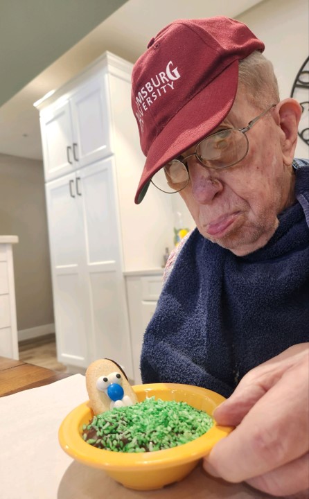 Elderly man enjoying a snack activity.