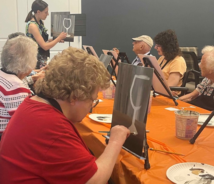 Residents engaged in a painting activity session.