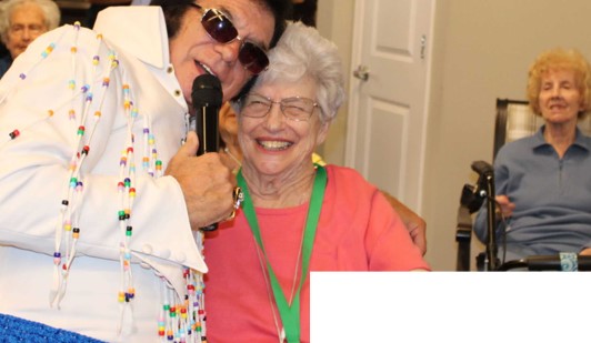 Resident enjoying performance with entertainer at event