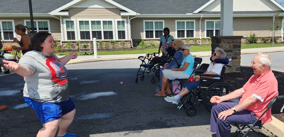 Residents enjoying an outdoor activity with staff.