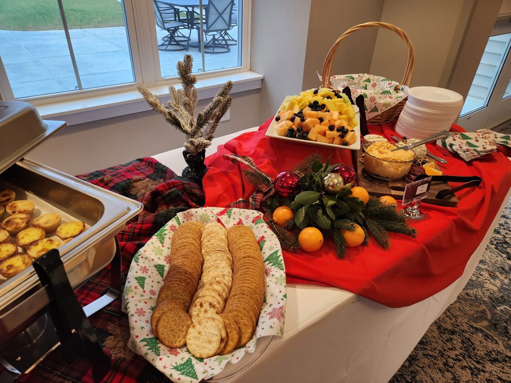 Table with assorted cookies and fruit platter