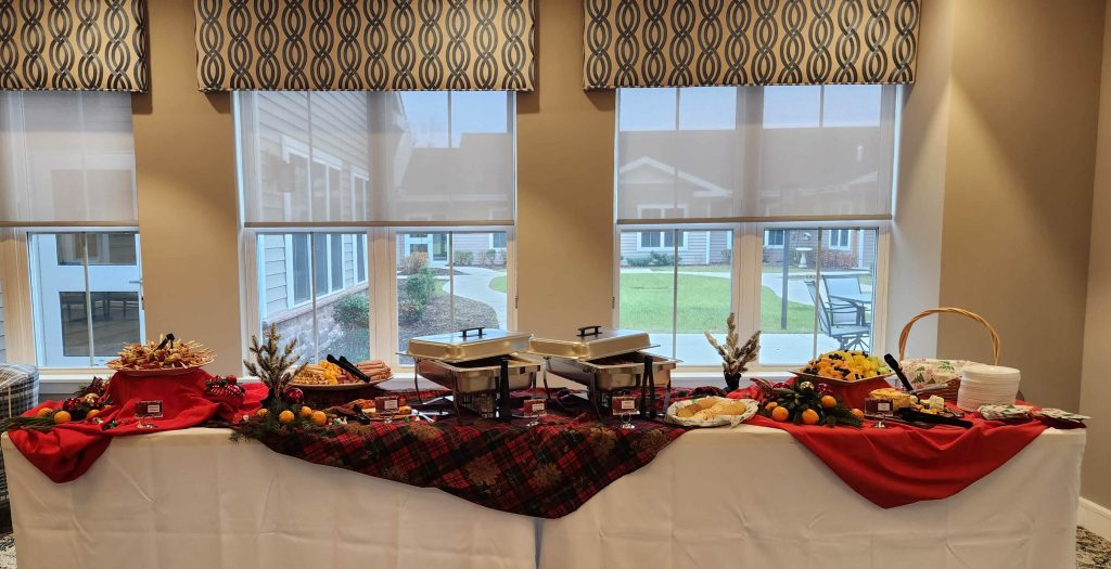 Buffet table with food and decorations in a dining area.